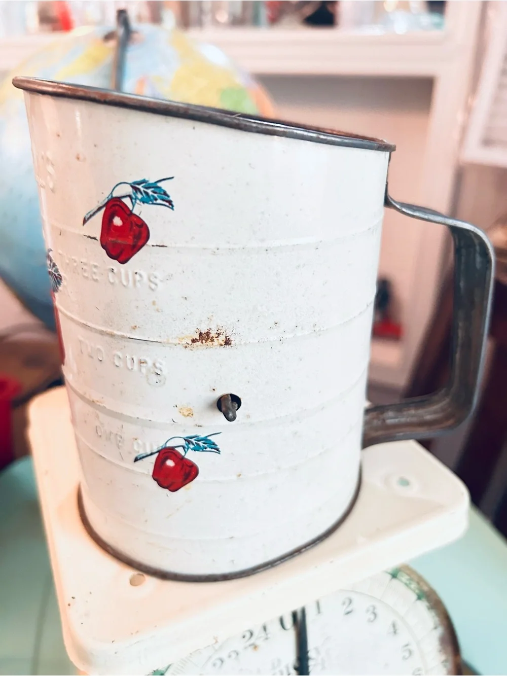 Vintage flour sifter with apple motif